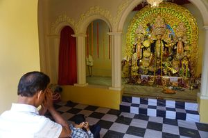 A devotee praying before the mother goddess Durga.