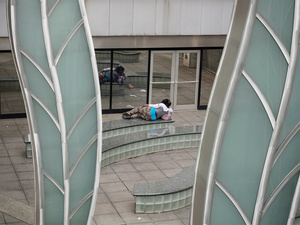 USA. Philadelphia. 2015. Lonely lady looking at herself in from of a mirror.