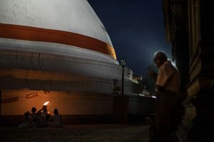Devotees praying at night in the temple.
