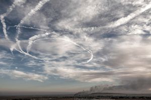 Smoke rises from an Islamic State position in the town of Kobane during airstrikes led by the US coalition  as trails of fighter aircraft are seen in the sky as seen from Mursitpinar on the outskirts of Suruc, near the Turkey-Syria border on November 9, 2014.