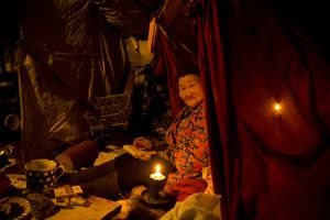 Irina Afonasyevna writing a letter. Allaiha. February, 2008 © Evgenia Arbugaeva