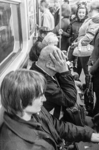 'Day's stress' reveals itself.   Kyiv bujsinessman suffers headache during afternoon commute home on one of three major Metro lines.  All provide fast, safe, comfortable and on time service throughout the system with valdalism almost unheard of.