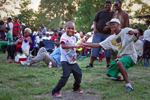 A boy, 4, dances with his grandfather as “Lady Champagne” sings on stage at John’s Carpet House. The boy’s father says the family lives on the East side of town, and they try to see the live performances often because their son is happiest when he is dancing.© Nicholas Gregory