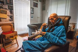 My father in his new chair looking at some old photographs.