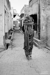 Woman taking home cowpats | Dhanda, Punjab.