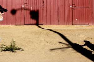 MAN WITH HAT ENTERS FRAME AND SHADOW
