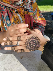 Fathima applying Henna to Rida