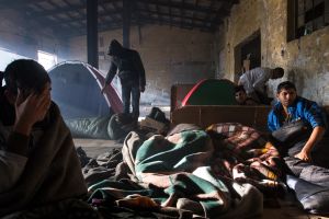 Awakening refugees in an abandoned warehouse,