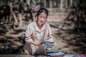 A farmer's wife selling souvenirs in Ban Long Lan village Luang Prabang Province.Laos.
