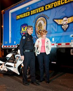 Officer bringing Driver suspected of being Under the Influence to Mobile Processing Van