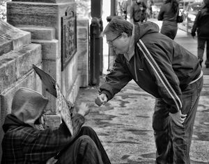 Fist bumping the homeless guy.