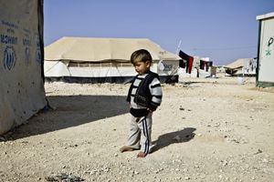 A little boy next to his tent home. © Tom Verbruggen