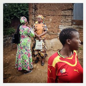 Women talk outside a house in Kibera. The Kibera slum is the largest slum in Nairobi with around half a million inhabitants.