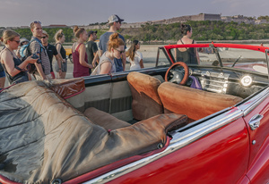 Tourists admire a American vintage Crysler on Havana's Malecón walk.
