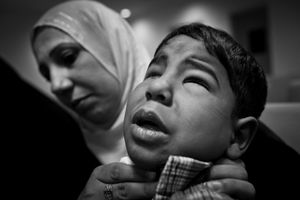 © Christian Werner - Iraq, Basrah, 23 April 2012 –In the children’s hospital in Basrah, a woman sits with her son on her lap, waiting for treatment. The boy was born without eyes.