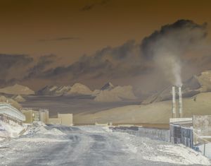 Smoke emission from the coal mining in Barentsburg. The Esmark glacier is pictured in the background.