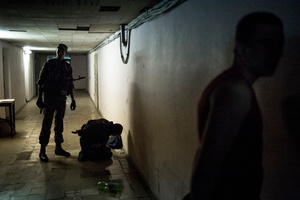 Rebels arrest a locals during a curfew