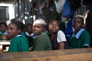 Sinai slum, Nairobi, KENYA, 29.10.2013: Schoolchildren attend math class at Jobenpha Community School. Mr. Joseph Owegah, the chairman and one of the founders of the school, built the school in 2000 with only 40 pupils attending. Today there are 940 children who are taught by 14 teachers.