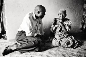 An old woman which wears traditional clothes talks with a young man. Almost every day young people visits older citizens to get suggestion or inspiration about life or work © Nicola Angelo Mangia