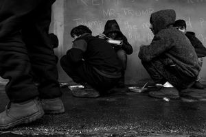 Refegees during the meal at a makeshift shelter near main train station in Belgrade, Serbia.