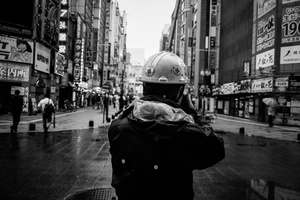 A construction worker take some measure in the centrale area of Kabukicho