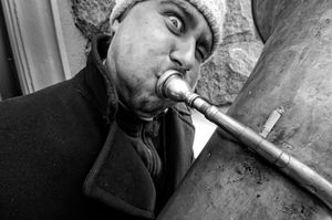 Kyiv,  A busker parks his cigarette while playing jazz as part of his trio's busking on most prestigious  downtown shopping street