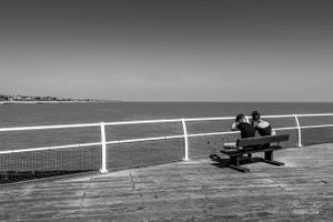 Couple sitting on Clacton on Sea pier