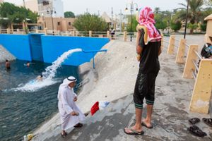 Boy has his towel on his head after finish swimming