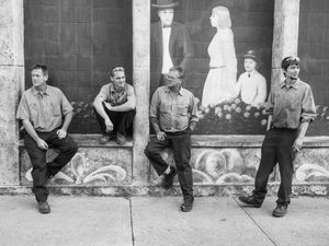 A group of electric motor workers take a smoke break.