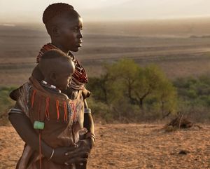 Portrait of Karo woman with her little child taken in the soft light of sunrise