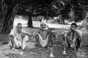 Men smoking hukhas in the village square  | Dhanda, Punjab.