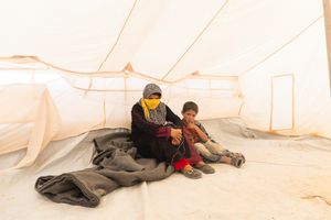 Safiyyah and Qadir, her son, are from southern Syria. Like many urban refugees in Jordan, they're rural farmers who don’t have any savings or valuables to speak off. They can’t afford exorbitant rents, which continue to rise. They have to find shelter wherever available with many having to live in tent at the edge of towns or nestled in between industrial estates. © David Brunetti