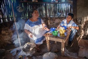 Doña Celestina Pat and her grandson Edgardo Moo Kahuil in the kitchen