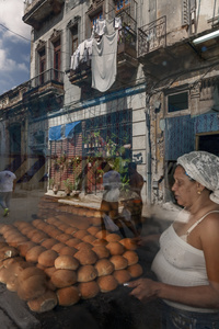 Havana street scene with reflection of a bakery window.
