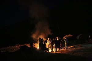 Local people gathered around fire while chatting about the damage of earthquake