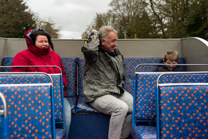 A bit nippy, hoods UP, aboard a cabriolet bus in the park.