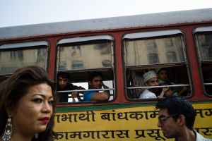 A hijra walks past a bus load of curious on-lookers during Mumbai's gay pride march.  © Alison McCauley