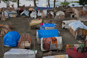 Flood affected people take shelters in the temporarily built house made of bamboo and plastic sheet. Satkhira, Bangladesh