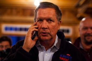 Republican presidential candidate Gov. John Kasich of Ohio leaves a voicemail for the son of an audience member who couldn't be at the house party in Center Tuftonboro during a campaign bus tour through New Hampshire on Wednesday, Oct. 14, 2015.