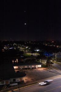 Motel Under Witching Moon with Passing Car