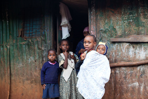 Juakali Slum, Nairobi, KENYA, 04.11.2013: Many children are not attending school to help raise their siblings while their parents are at work.