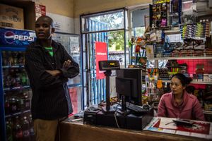 Wife of Chinese shopkeeper with guard