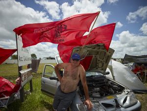Gauchito Gil flags retailer in Mercedes town for the celebrations of January 8, date of the murder of the popular saint