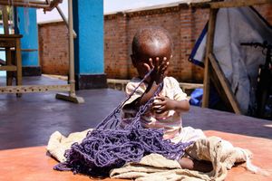 Toddler Plays Pee-a-Boo with Hand-spun Yarn, Musanze Rwanda Africa