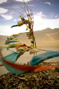 There are prayer flags everywhere in Tibet. They’re thin cloth printed with prayers, blessings and bits of Buddhist scripture. The Tibetans hang them from their houses, near holy places, along roads and bridges, and up the sides of mountains. They believe that when they flutter in the wind, a prayer is sent up to heaven. © Forest McMullin