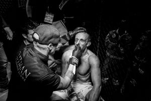 As the fight ends with a technical knockout, the Italian Marco Manara, defeated, is treated by the cutman, who monitors his condition and tampons his wounds.