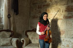 Ala Shalalda is a young musician who studies the violin at Al Kamandjâti, which first opened in 2005 and is located next to her home. Her older brother, Shehada, trained to become a violin maker in the UK. Ala practices on the very first violin her brother made daily. Ala has been studying the violin for six years and she hopes to become a professional musician. © David Brunetti