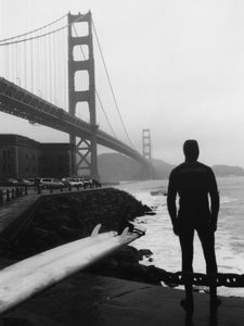 Preparing to ride the waves under Golden Gate bridge in San Francisco