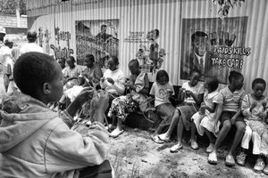 HIV AIDS KILLS: Orphan and abandoned children adopted by Charles and Esther Mulli knit happily outside a dorm room.                           © Lola Reid Allin