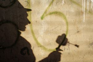 The Lingkor is a devotional route followed by pilgrims that encompasses much of Lhasa, Tibet. It includes rock paintings, prayer wheels, sangkangs (incense burners), and many other, more secular sights.This shadow is of a man walking along, spinning a prayer wheel. Photographed on 29 June 2005 © Forest McMullin